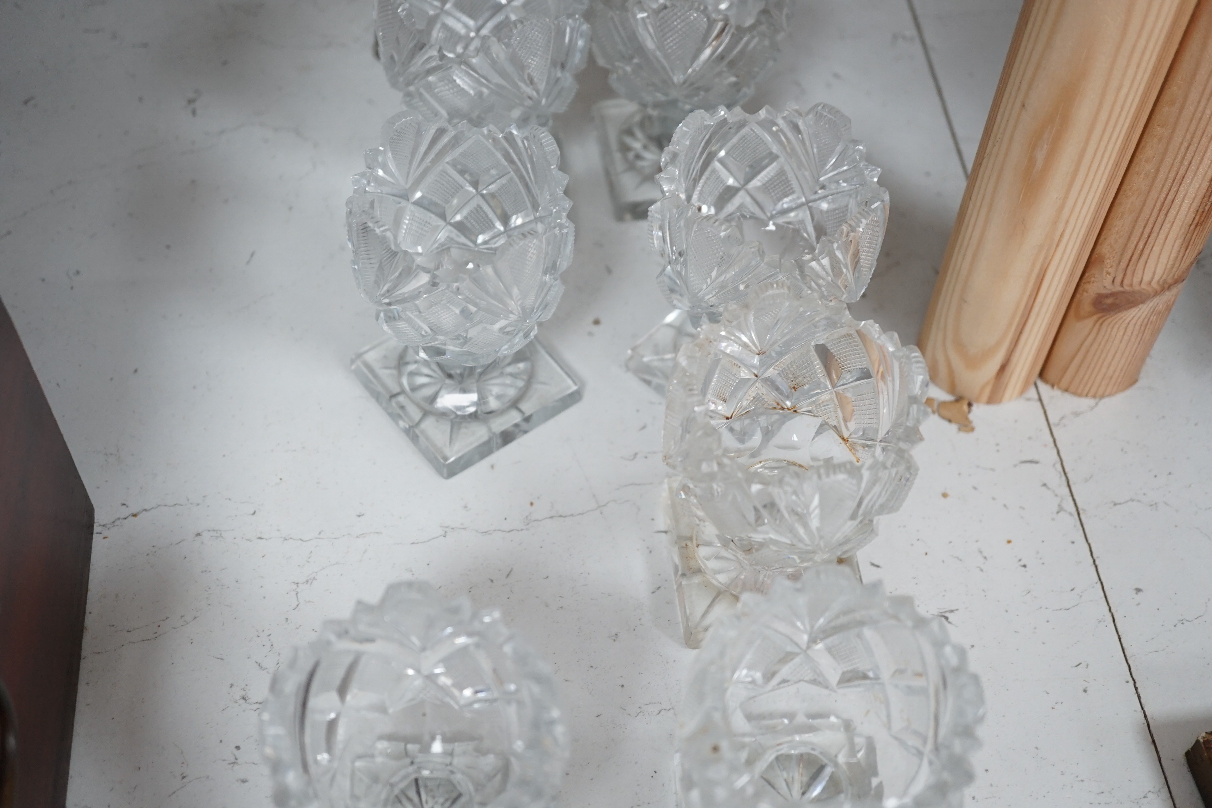 A set of twelve Victorian square base cut glass salts and four other 19th century clear glass salts.